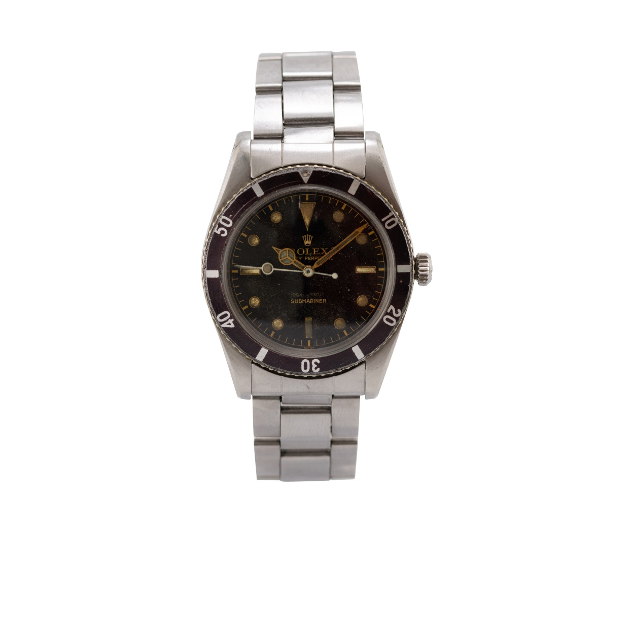 Rolex Submariner réf. 6536/1 de 1957, sans protège-couronne, cadran noir doré patiné et lunette virée au mauve